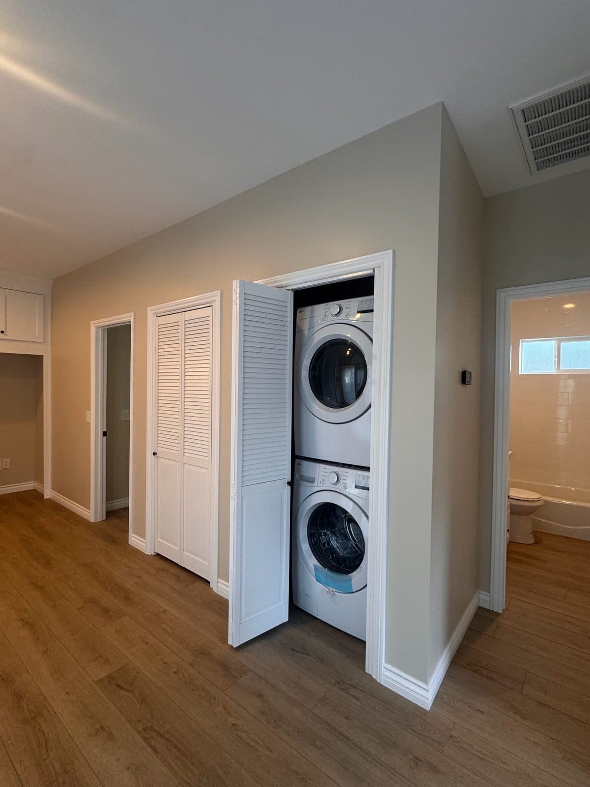 MJ Remodel job photo from an ADU completed in Redlands, CA: finished laundry closet with a stacked washer and dryer