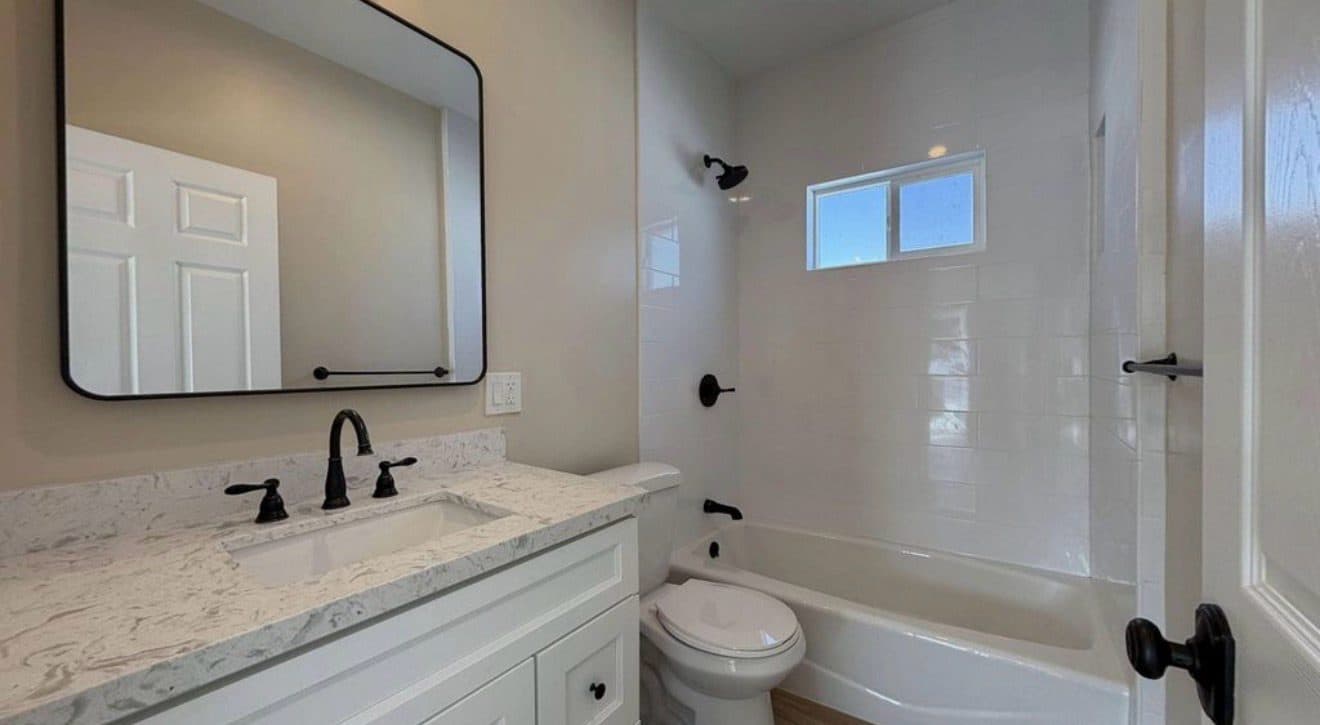 MJ Remodel job photo from an ADU completed in Redlands, CA: bathroom with a tub and shower combo and matte black fixtures