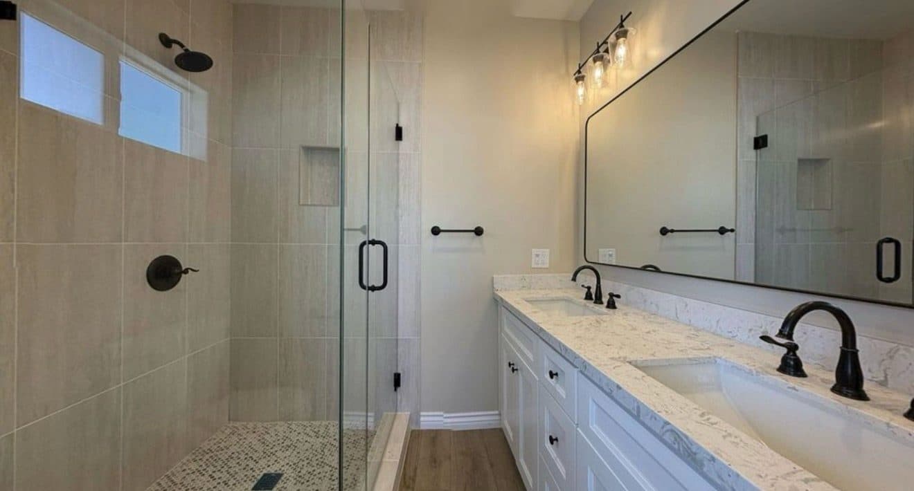 MJ Remodel job photo from an ADU completed in Redlands, CA: bathroom with a frameless walk-in glass shower and double vanity